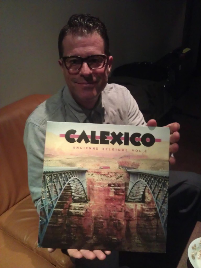 John Convertino of Calexico holding the vinyl LP of the new Ancienne Belgique Volume 2